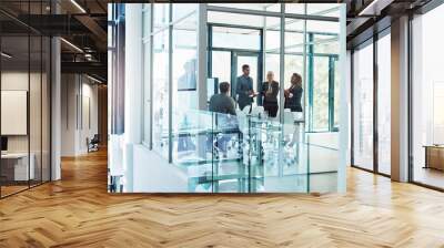 Lets delve into the details. Full length shot of a group of corporate businesspeople meeting in the boardroom. Wall mural