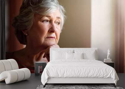 She has a lot on her mind. Shot of a senior woman looking thoughtful. Wall mural