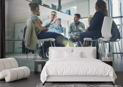 Teamwork, collaboration and strategy planning of business team working together indoors. Modern office workers talking and sitting in a group meeting. Colleagues work and talk about a project Wall mural