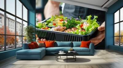 person holding a plate with vegetables, box of healthy food Wall mural