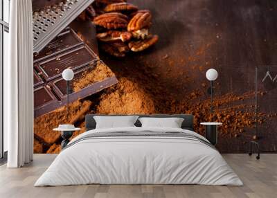 Chocolate products. Chocolate, cocoa beans, cocoa and nuts on wooden background.  Wall mural