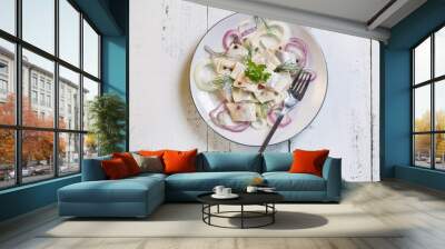 Herring pickle with onion, oil, pepper and dill on plate. Wall mural