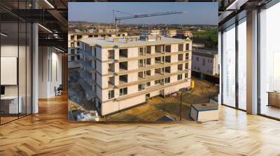 Multi-family building under construction, aerial view. Wall mural