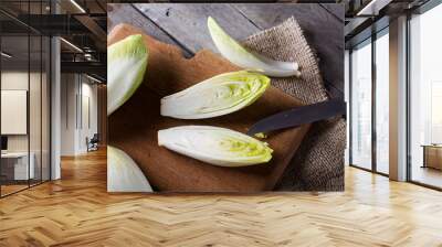 Top view on endive lying on wooden background. Wall mural