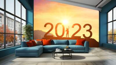 2023. Welcome Happy new year 2023. Man meets dawn in mountains. happy New Year 2023. New Start motivation inspirational quote message on silhouette of winner woman Wall mural