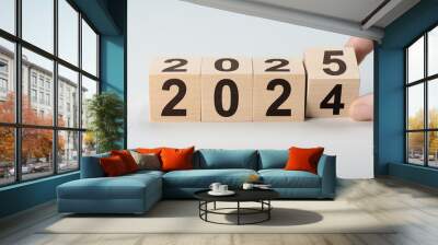 2025 happy new year, Flipping of wooden cube block change from 2024 to 2025. Wooden cube with flip over block 2024 to 2025 number. Business management, Inspiration to success ideas and goals. Wall mural