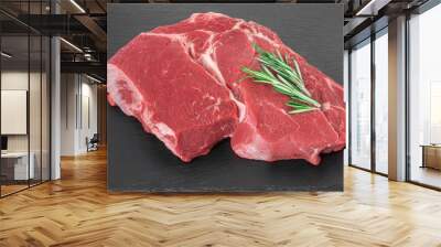 beef meat with rosemary on a black stone board. Fresh piece Raw beef Wall mural