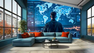 Big Empty Data Monitoring Center with Global Map on huge Digital Screen. person back view stands in operations command center. Futuristic global surveillance control room with multiple screens. Wall mural