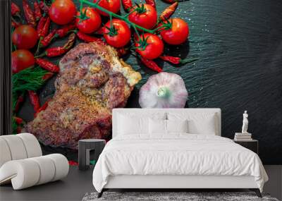 Juicy piece of grilled meat with tomato, garlic and pepper Wall mural