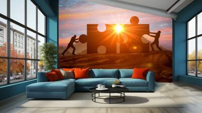 Teamwork, partnership and cooperation. Business concept of teamwork with puzzle. Silhouettes of two businessman connect two pieces of puzzle together. Teamwork and integration Wall mural