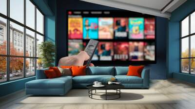 tv online. television streaming video. male hand holding tv remote control. multimedia streaming con Wall mural