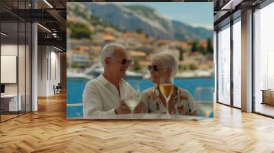 A retired couple sharing a romantic moment on a luxury yacht, enjoying the scenic views of a coastal town under the sun Wall mural