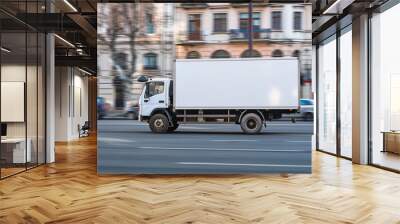 A white delivery truck moving along a busy city street, illustrating urban logistics and transportation Wall mural