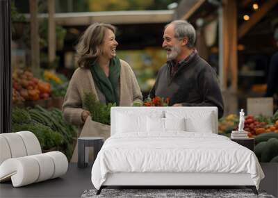 Senior couple is laughing while carrying bags of fresh produce at the farmers market Wall mural