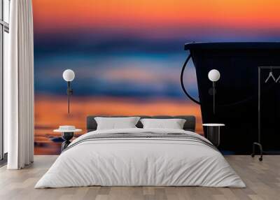 a bucket in the beach and sun rise. Wall mural