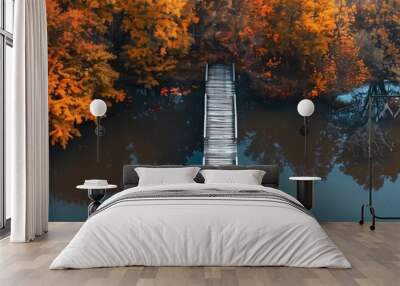 A wooden dock leading into a lake with trees in the background Wall mural