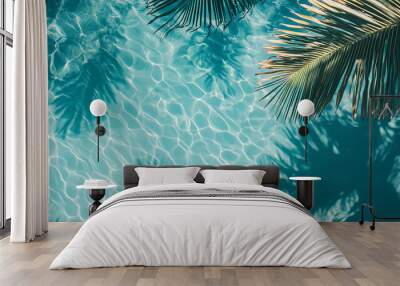 Top view of a blue calm and clear calm water surface, water texture with ripples and shadow of palm leafs, Zen and relaxing background, summer concept Wall mural