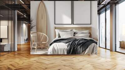 A minimalist bedroom with a surfboard, a bed with white bedding and a brown blanket, a wooden side table with books and a vase with a dried palm frond, and two framed prints of a beach scene above the Wall mural