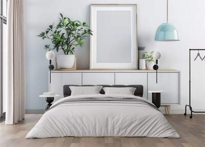 A white sideboard with wooden legs and a wooden frame. with two potted plants and a pendant light. against a white wall Wall mural