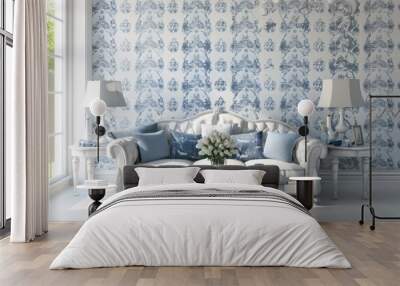 A white sofa with blue pillows sits in a room with white walls and a blue and white floral wallpaper. There is a coffee table and two lamps in the room. Wall mural