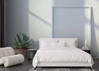 Empty white frame mockup with a succulent plant in a wooden pot on a white shelf against a white wall with sunlight coming through the window Wall mural