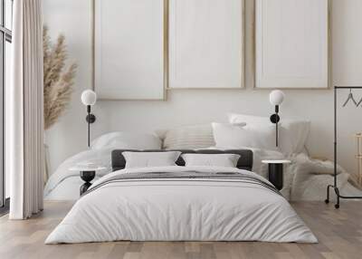 Minimalist bedroom interior with a wooden bed frame. white bedding. and a throw blanket There are two empty picture frames on the wall and a vase with pampas grass on the nightstand Wall mural