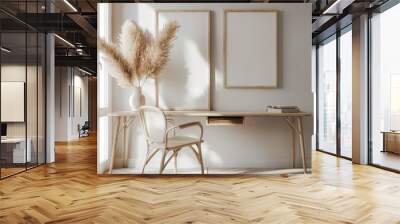 Minimalist home office interior with wooden desk. chair. and two empty picture frames against a white wall with pampas grass in a vase Wall mural