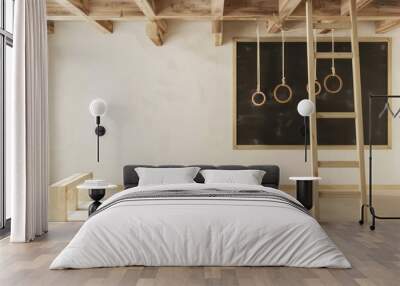 Minimalist interior design with wooden beams, a chalkboard, a wooden ladder, and gym rings. Wall mural