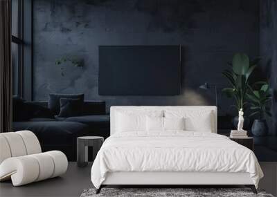 Modern living room with dark grey walls, a large black TV, and a black sofa. The room is illuminated by a table lamp Wall mural