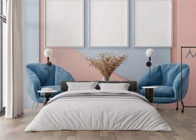 Three blank frames on a pink and blue wall above a white coffee table with two blue chairs and dried flowers in a vase Wall mural