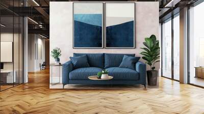 Two abstract blue and white geometric wall art prints framed and hung above a blue sofa in a living room Wall mural