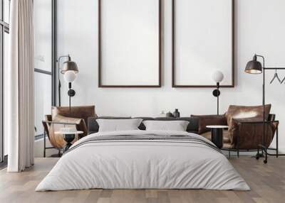 Two brown leather armchairs with black metal frames are placed on a wooden floor in front of two empty picture frames in a modern living room with a large window Wall mural