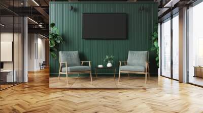 Two comfortable armchairs face a flat screen television in a minimalist green room A small coffee table sits between the chairs with a cup of coffee and a small plant The wall is a deep green color an Wall mural