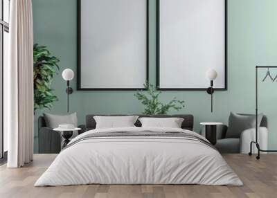 Two empty frames with black frames hanging on a light green wall above a coffee table with two armchairs. a vase with a plant. and a cup of coffee Wall mural