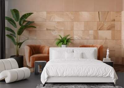 Two orange velvet chairs with a black round table and two plants in pots in front of a beige tile wall Wall mural