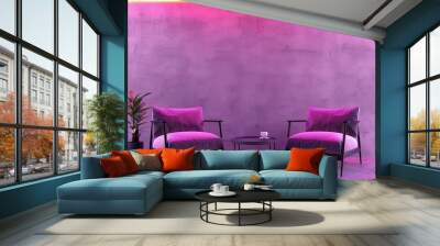 Two plush armchairs and a coffee table, set against a pink and yellow neon lit concrete wall, perfect for a modern, minimalist interior design. Wall mural