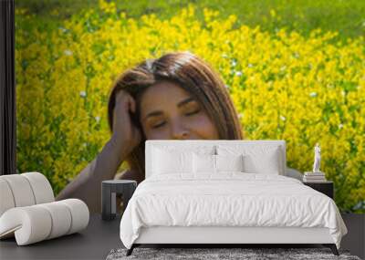 beautiful mexican woman enjoying picnic in field full of flowers with relaxed face Wall mural