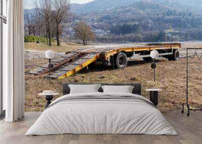 Truck-wheel road trailer in a grassy meadow Wall mural