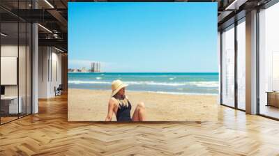 young woman relaxing on the beach Wall mural