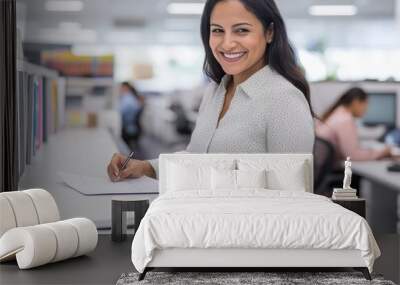 attractive hispanic woman in her late thirties, wearing business casual attire and smiling Wall mural