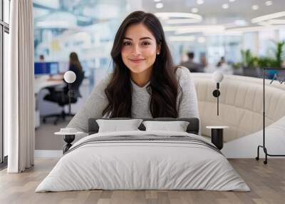 attractive hispanic woman in her late thirties, wearing business casual attire and smiling Wall mural