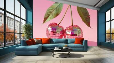 two cherries that are disco balls on a pastel light red background
 Wall mural