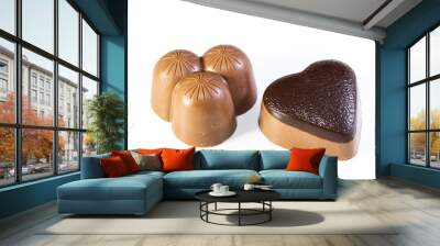 Two milk chocolates, one heart shaped and the other triple shaped on white background Wall mural