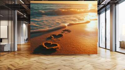 A tranquil beach scene at sunset with heart-shaped footprints in the sand Wall mural