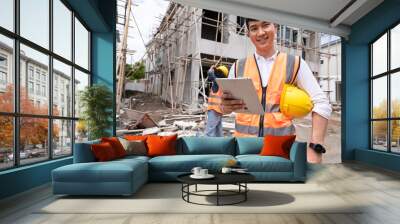 Confident engineer holding tablet on construction home building site	 Wall mural