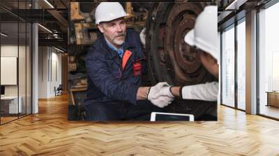 Engineer man check hand with engineer team at factory spares train Wall mural