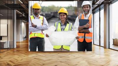 India engineer woman holding paper work with team engineer man at precast site work Wall mural