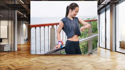 Portrait beautiful Asia woman checking smart watch after exercise jogging	 Wall mural