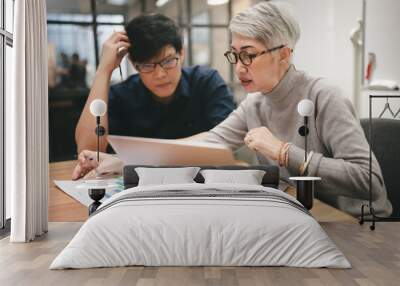 Senior businesswomen working with businessman in office Wall mural