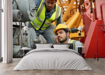 Two Asia engineers man worker checking machine and use tablet computer with spare crane background	 Wall mural